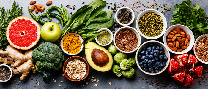 A variety of fruits, vegetables, and herbs displayed on a table